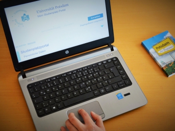 (Credit: sciencehoch3) Ein aufgeklappter Laptop mit der Webseite der Universität Potsdam